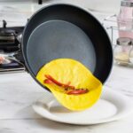 Best non-stick pans of 2026 shown on stovetop with eggs cooking in a PFOA-free skillet